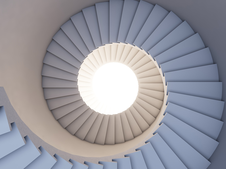 spiral staircase viewed from above, featuring light at the center, showcasing modern architectural design